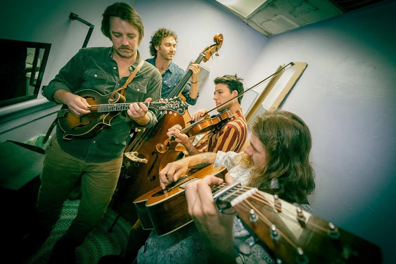 The Fretliners playing together backstage